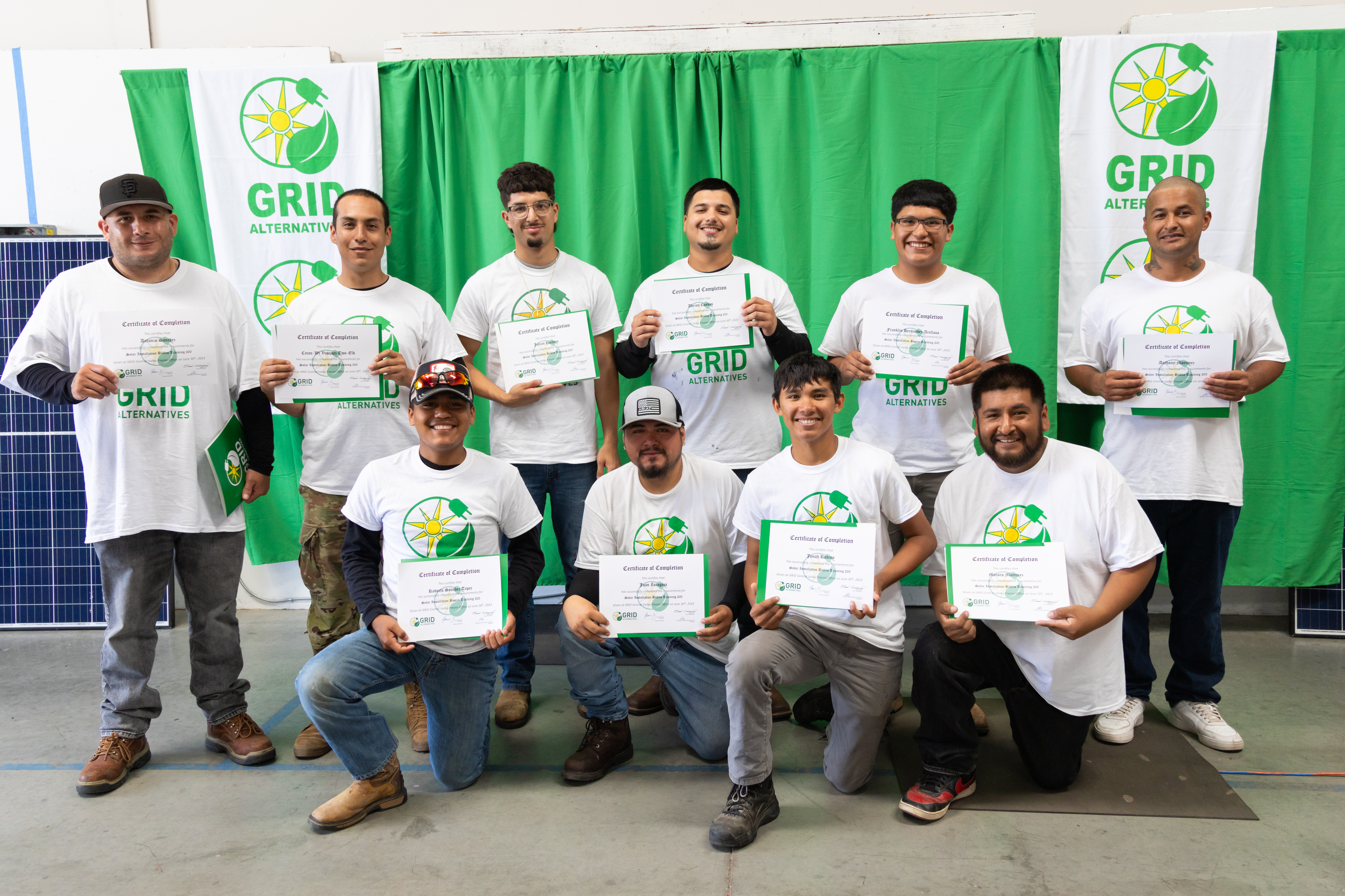 Large group of men posing for picture with graduation certificate
